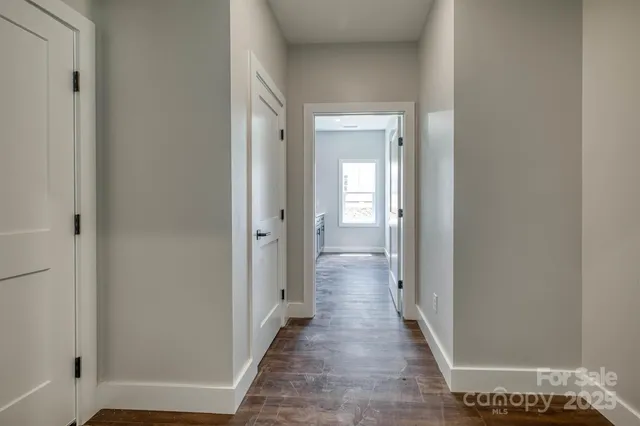 a view of a hallway with wooden floor
