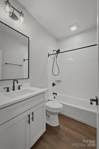 a kitchen with stainless steel appliances granite countertop a sink a stove cabinets and wooden floor