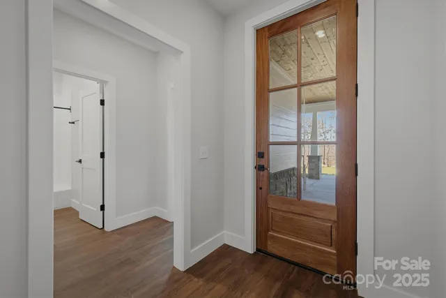 a living room with a floor to ceiling window next to a yard