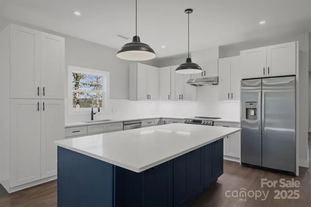a kitchen with a sink stove and refrigerator