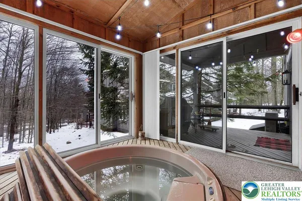 a living room with a large window and furniture