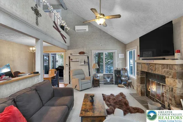 a living room with furniture fireplace and flat screen tv