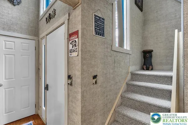 a bathroom with a sink a light fixture and a mirror