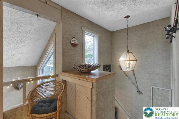 a living room with furniture a flat screen tv and a table