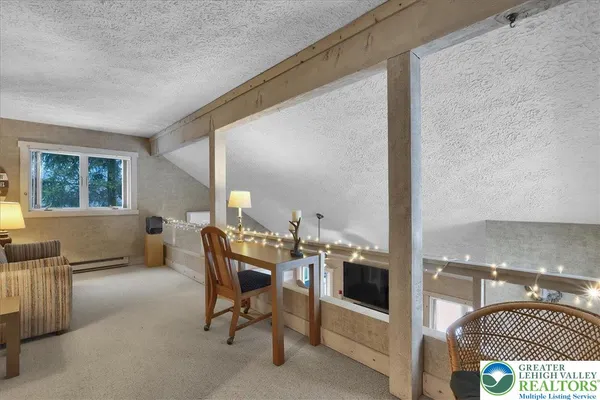 a bedroom with a bed and glass windows