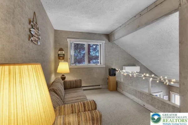 a kitchen with a table chairs refrigerator and a sink