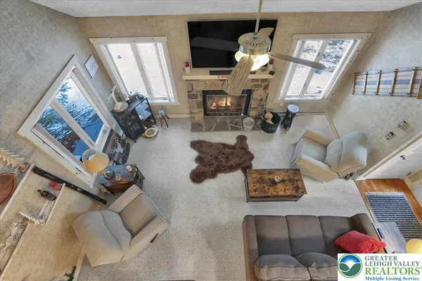 a bathroom with a granite countertop sink vanity mirror and toilet