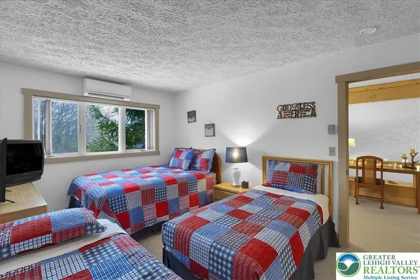 a bedroom with a bed and two lamp next to a window