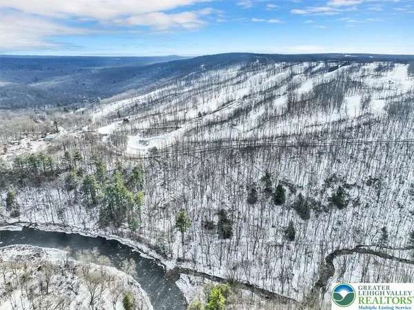 a view of a house with snow on the road