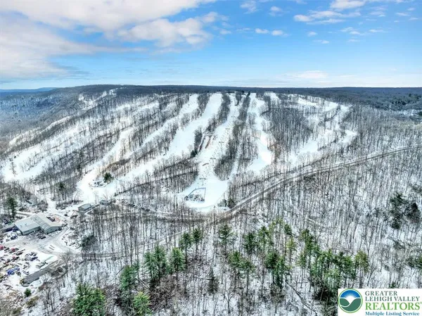 a tree in front of a white house