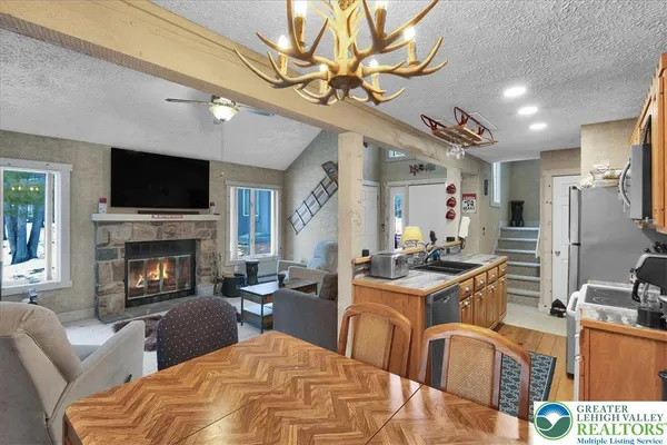 a living room with furniture a fireplace and a flat screen tv