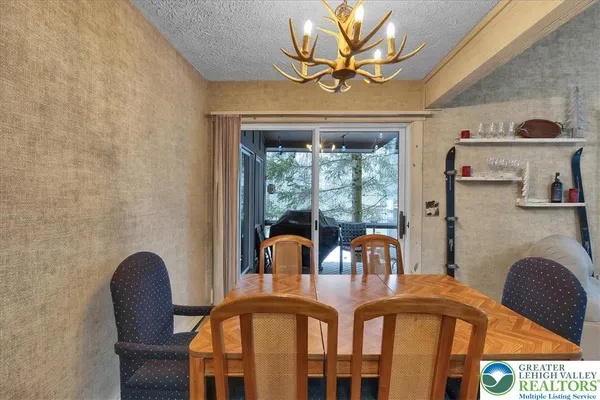 a view of a dining room with furniture and chandelier
