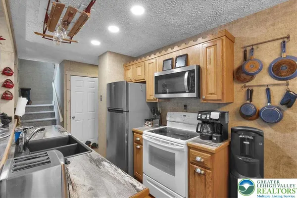 a kitchen with stainless steel appliances kitchen island a stove and a refrigerator