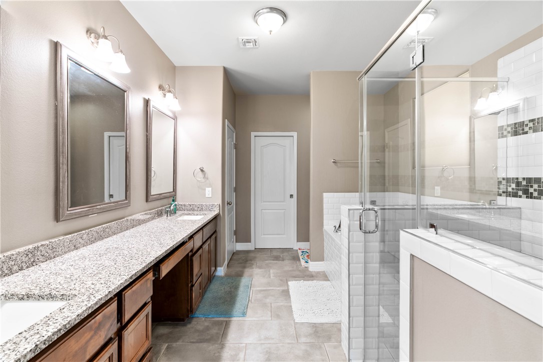 1815 Monterey Bay Drive Portland, TX 78374 - Photo 19 of 38 a bathroom with a granite countertop sink and a mirror