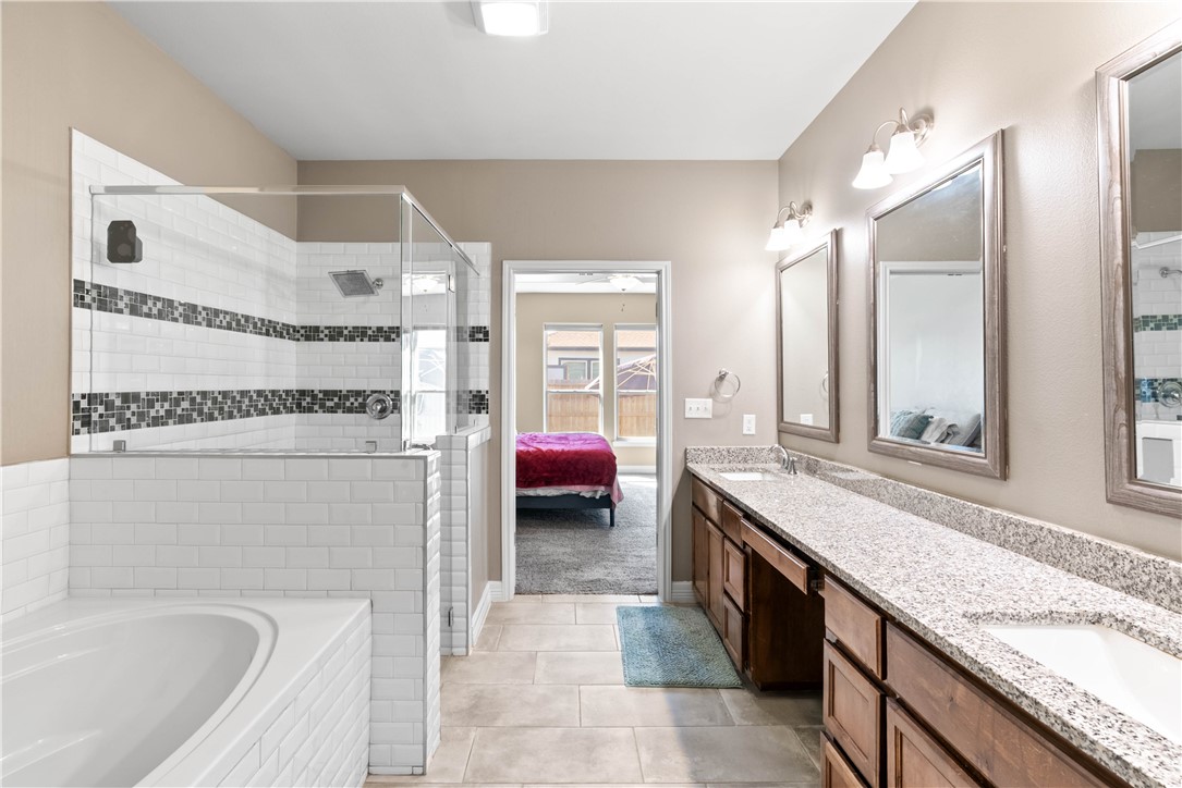 1815 Monterey Bay Drive Portland, TX 78374 - Photo 22 of 38 a spacious bathroom with a granite countertop sink mirror and bathtub