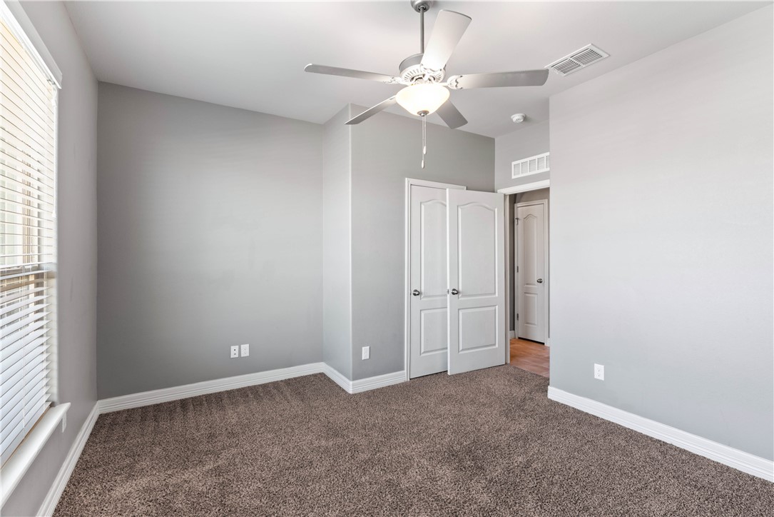 1815 Monterey Bay Drive Portland, TX 78374 - Photo 29 of 38 an empty room with a ceiling fan and window