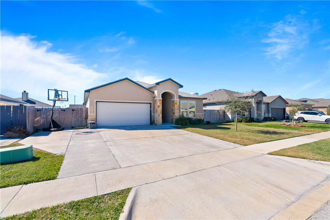 1815 Monterey Bay Drive Portland, TX 78374 - Photo 5 of 38 a front view of a house with a yard and garage