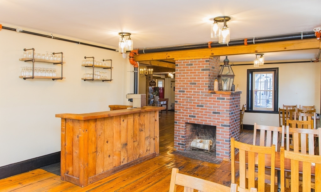 10 Baldwinville Road Templeton, MA 01468 - Photo 23 of 35 a living room with a fireplace furniture and a ceiling fan