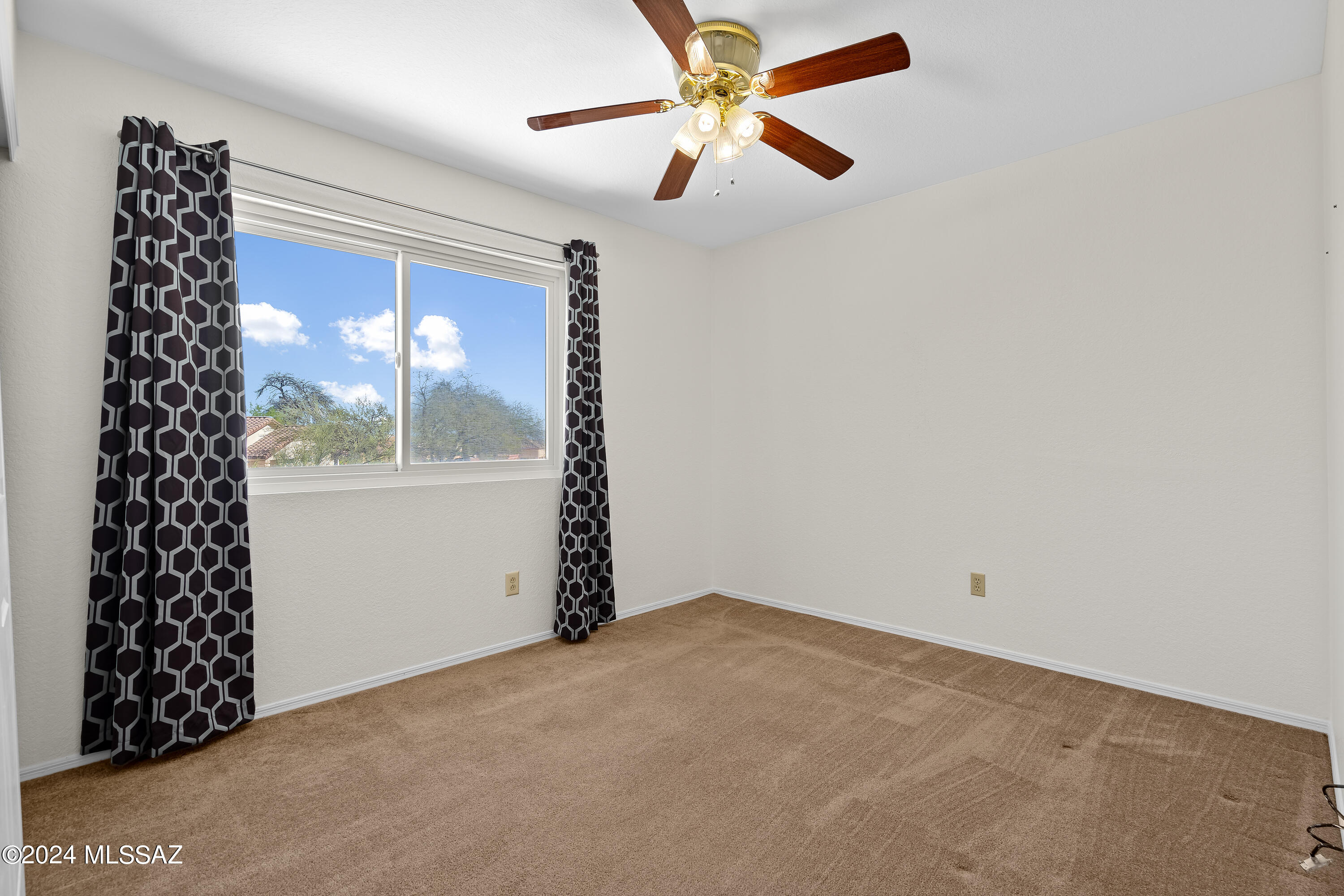 3476 West Sky Ridge Loop Tucson, AZ 85742 - Photo 21 of 31 a view of a big room with window and chandelier fan