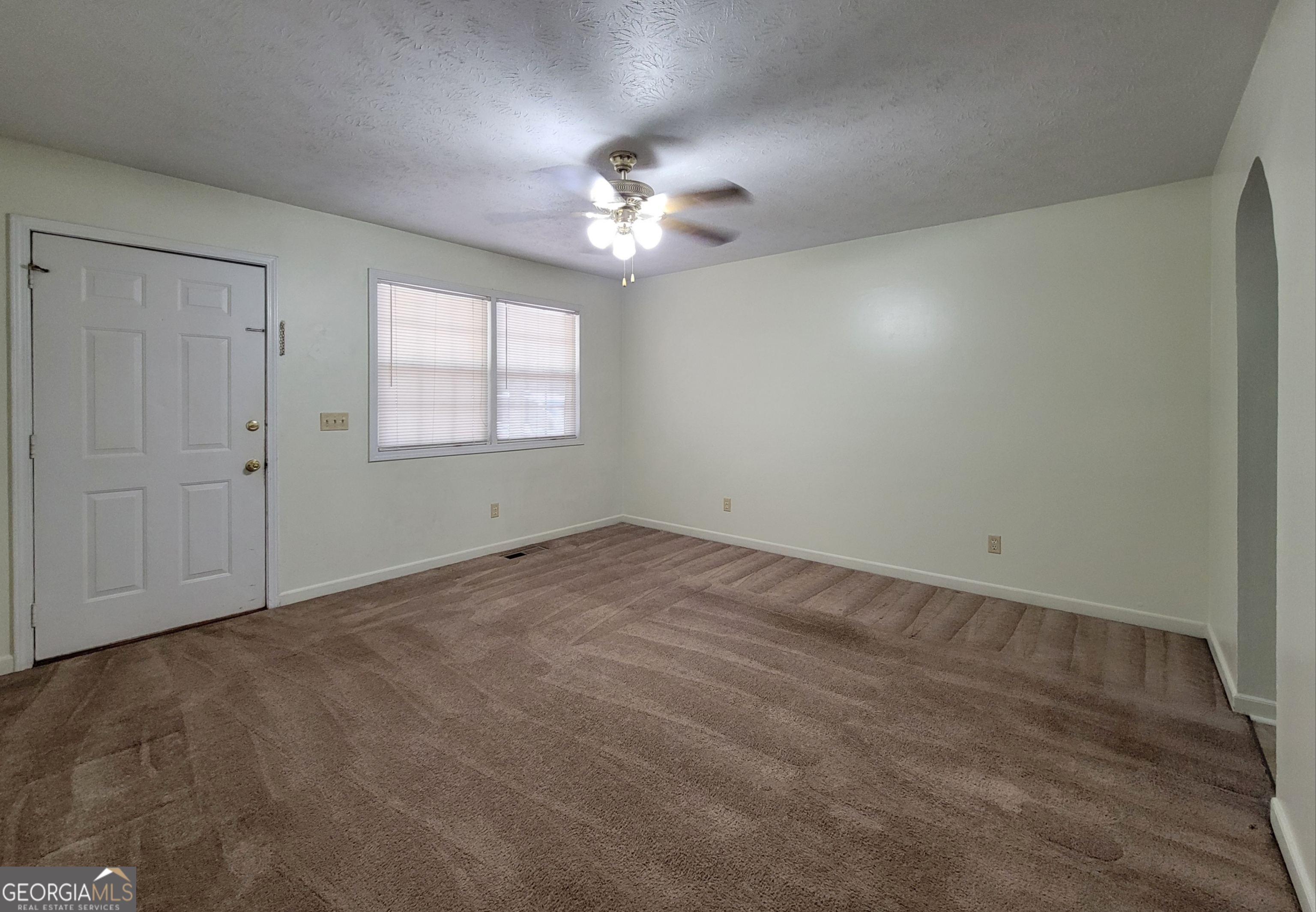8 Candlewood Terrace Northeast, Unit 2 Winder, GA 30680 - Photo 2 of 8 an empty room with windows and fan