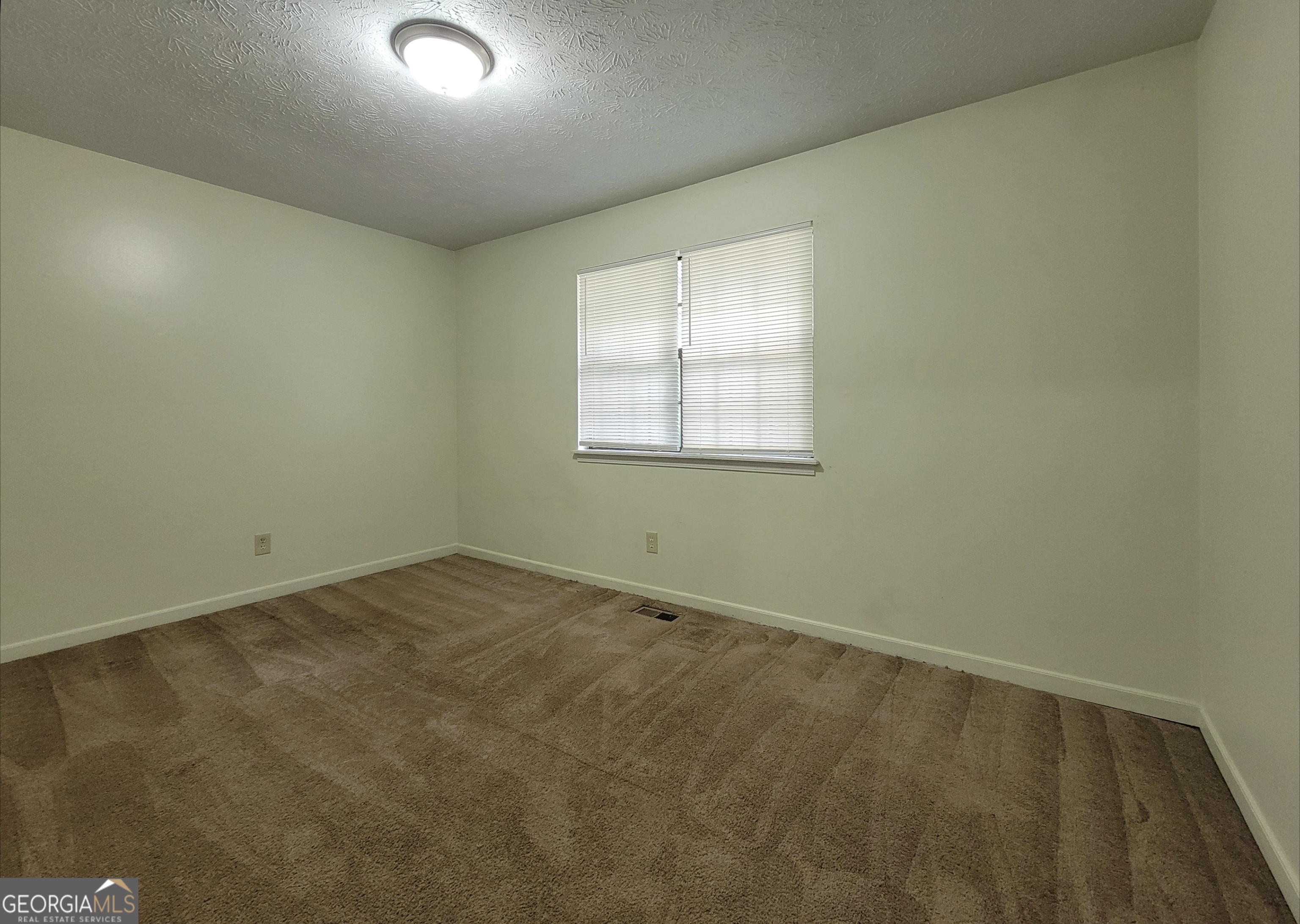8 Candlewood Terrace Northeast, Unit 2 Winder, GA 30680 - Photo 5 of 8 an empty room with windows