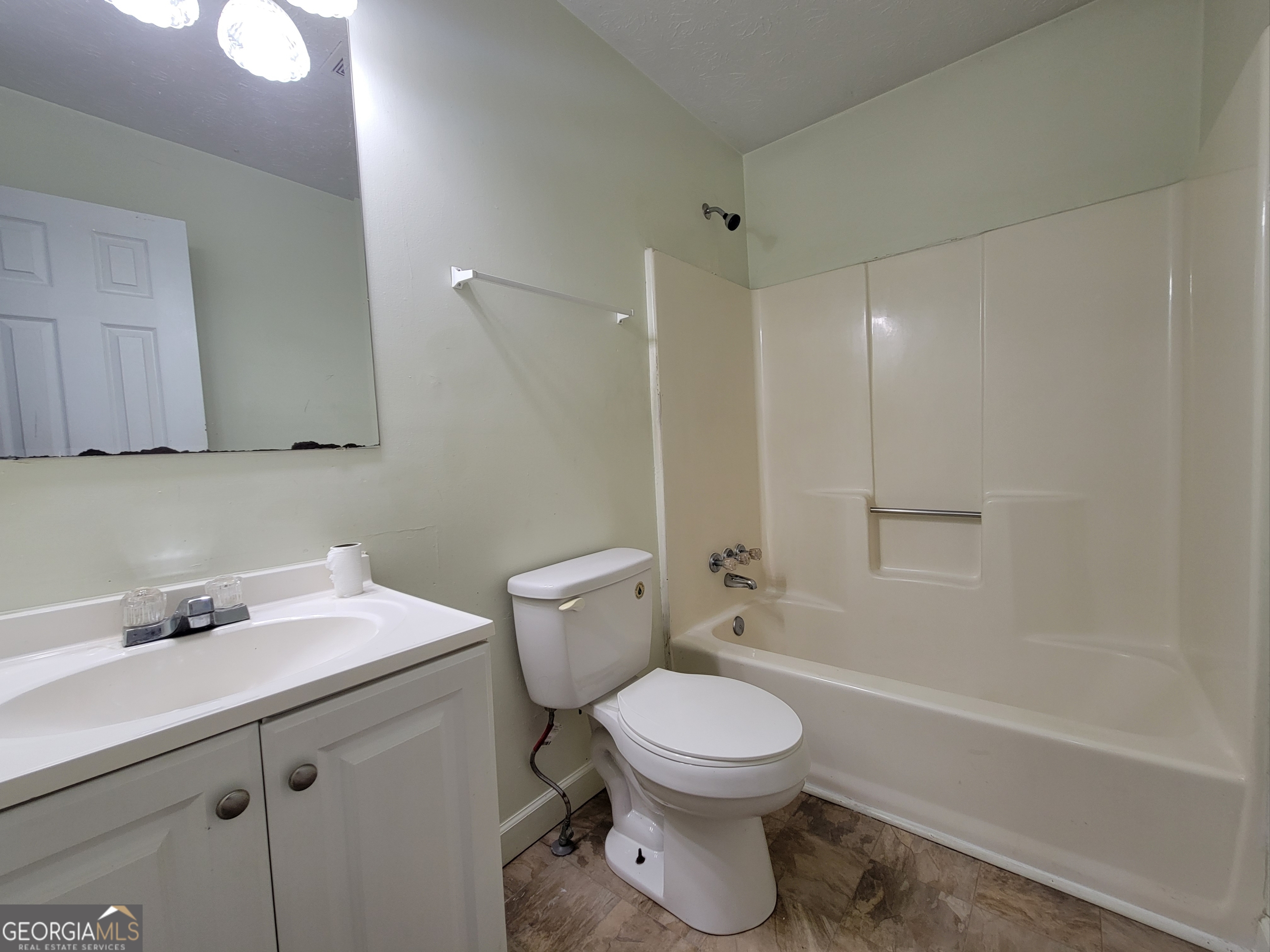 8 Candlewood Terrace Northeast, Unit 2 Winder, GA 30680 - Photo 6 of 8 a bathroom with a sink a toilet and shower