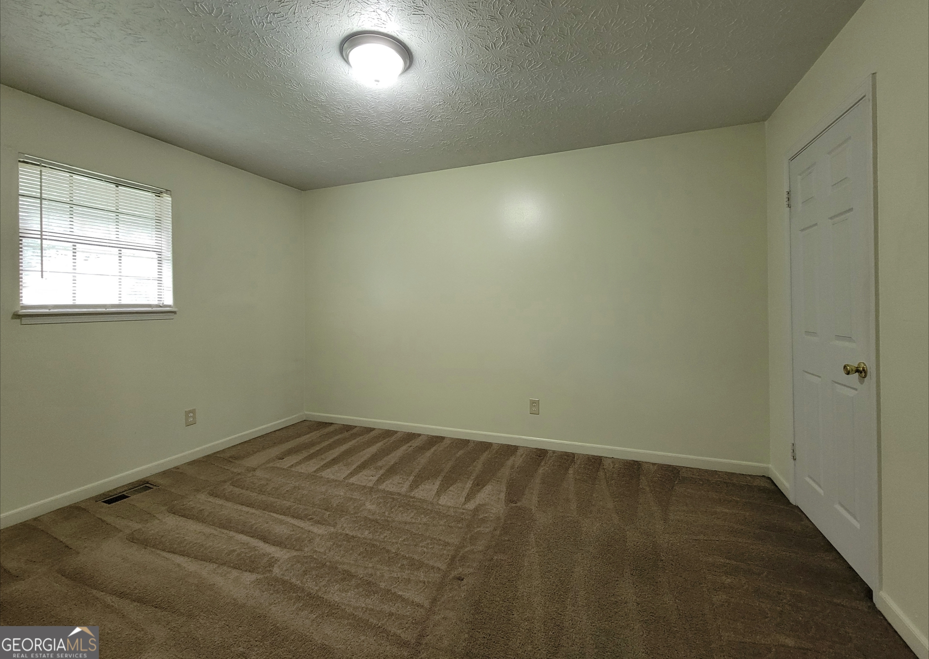 8 Candlewood Terrace Northeast, Unit 2 Winder, GA 30680 - Photo 7 of 8 an empty room with a window