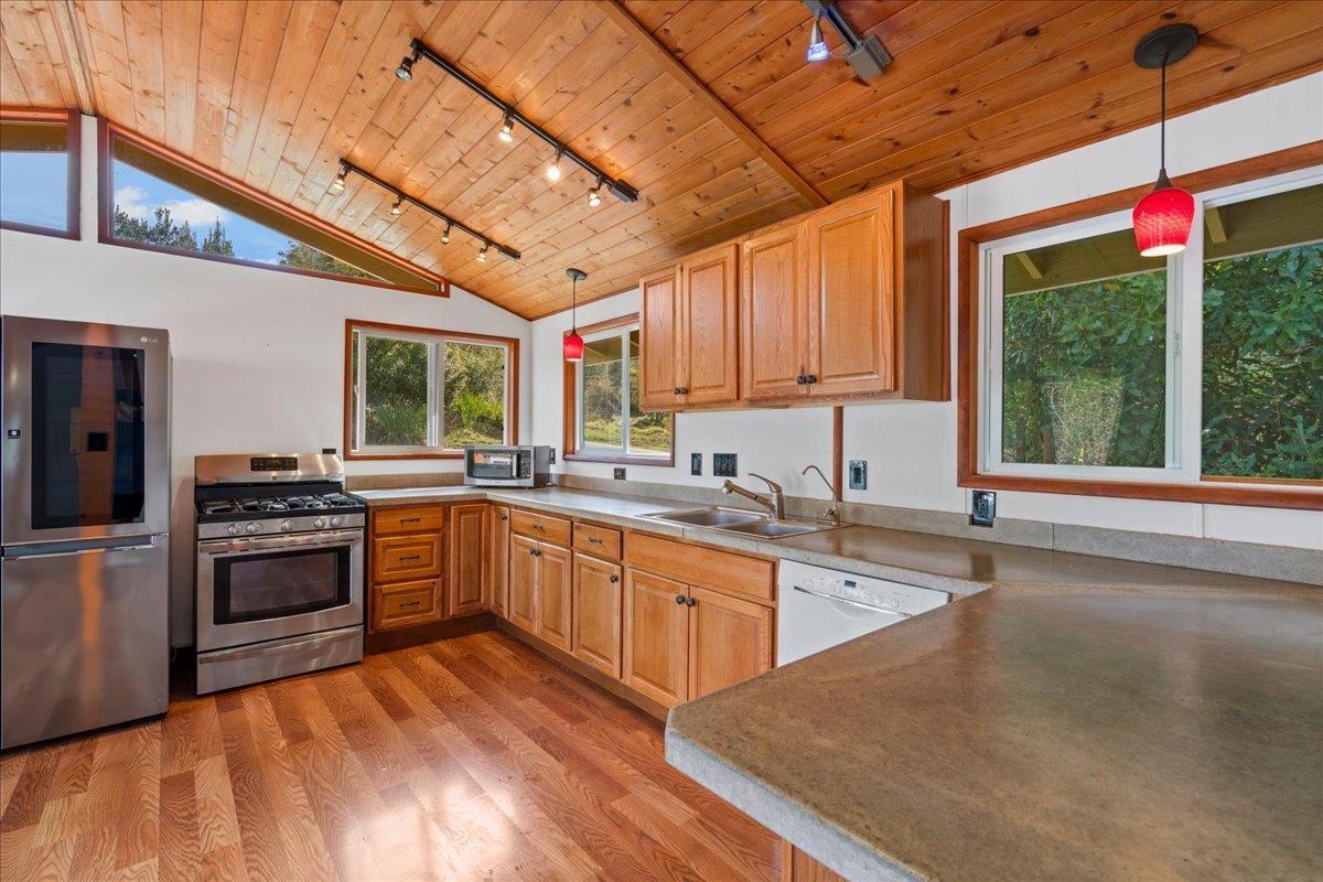 31 Hapapa Road, Unit B Kula, HI 96790 - Photo 11 of 50 a kitchen with stainless steel appliances granite countertop a stove sink and cabinets