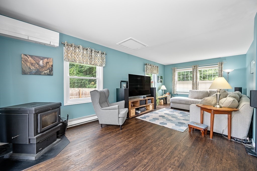 6 Edward Road Dudley, MA 01571 - Photo 13 of 28 a living room with furniture a flat screen tv and a window