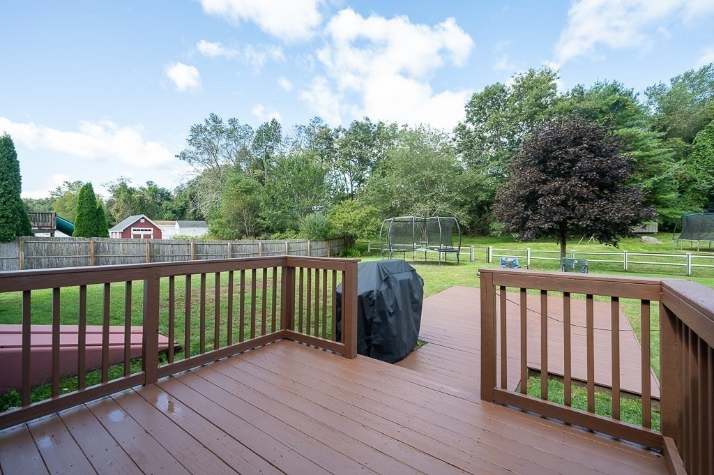 6 Edward Road Dudley, MA 01571 - Photo 25 of 28 a view of a deck with a floor to ceiling window next to a yard