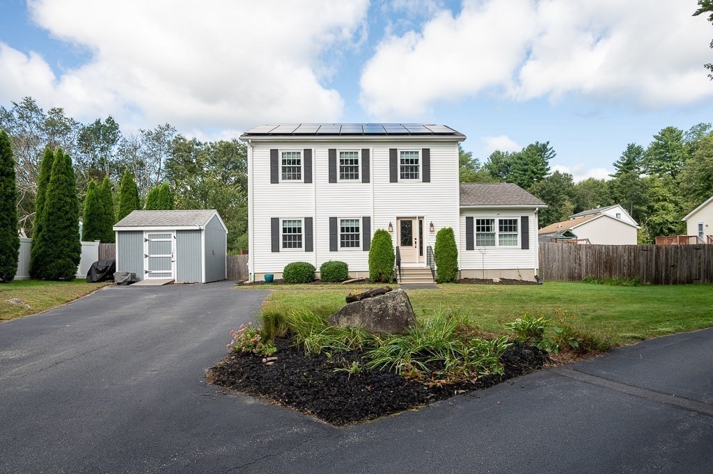 6 Edward Road Dudley, MA 01571 - Photo 3 of 28 a front view of a house with a yard and garage