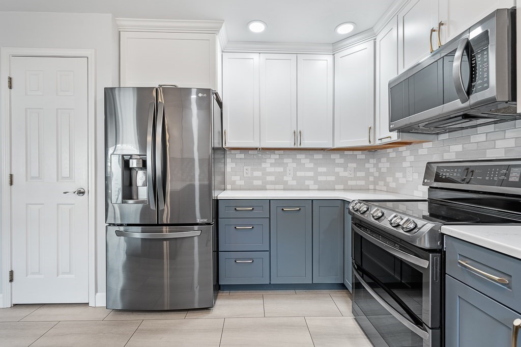 6 Edward Road Dudley, MA 01571 - Photo 5 of 28 a kitchen with stainless steel appliances granite countertop a refrigerator and a stove