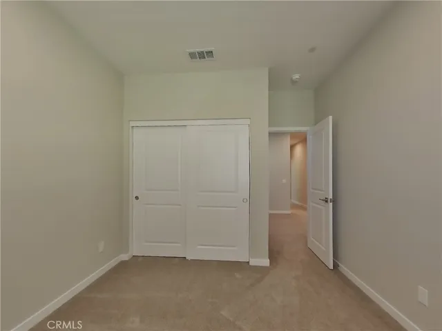 an empty room with closet area