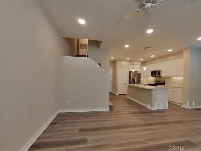 a view of kitchen with wooden floor and a sink