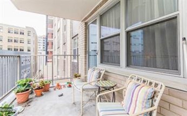 151 Tremont Street, Unit 7B Boston, MA 02111 - Photo 11 of 14 a view of a patio with a table and chairs and potted plants