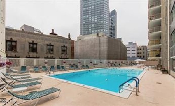 151 Tremont Street, Unit 7B Boston, MA 02111 - Photo 13 of 14 a view of a swimming pool with chairs