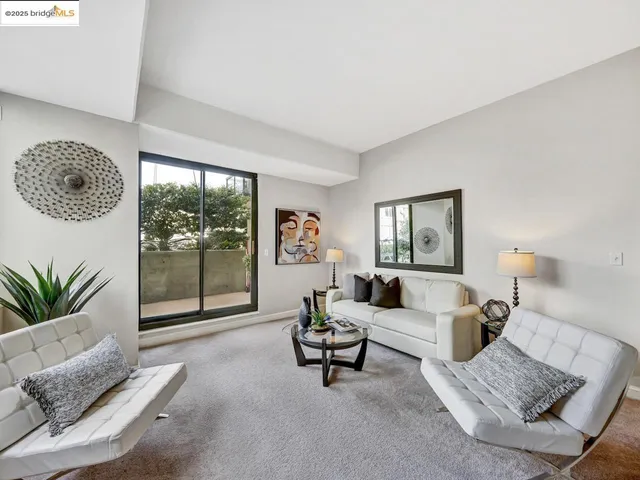 a living room with furniture and a floor to ceiling window