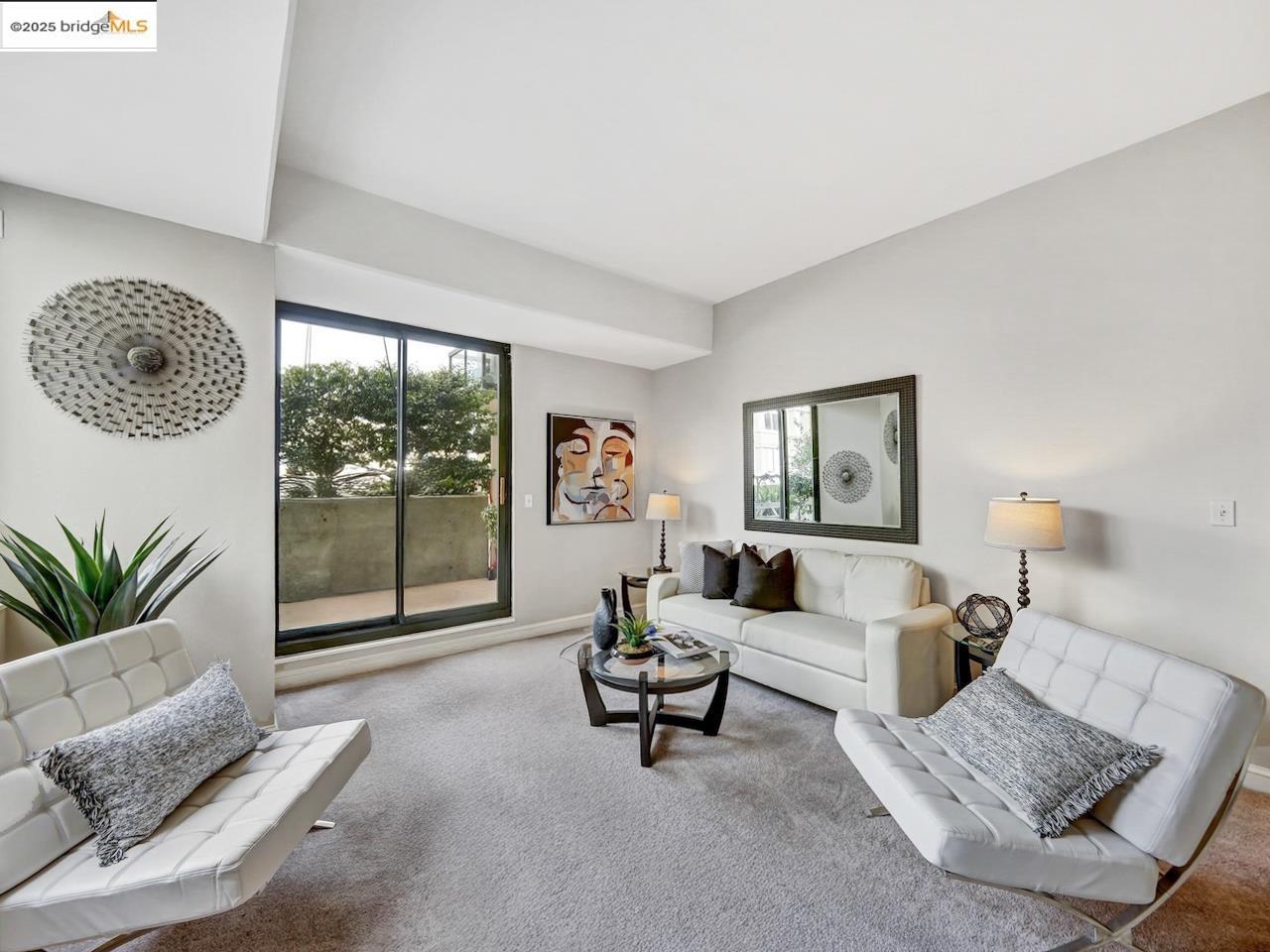 a living room with furniture and a floor to ceiling window