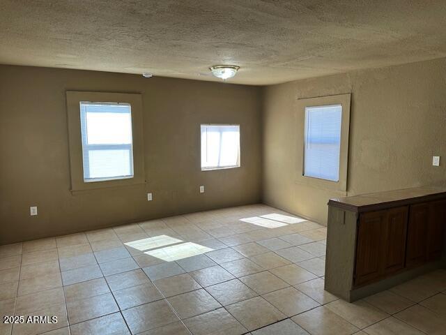 1000 East Garfield Street Phoenix, AZ 85006 - Photo 11 of 12 a view of an empty room with window and chandelier fan