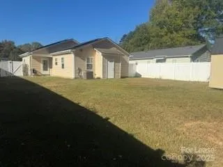 a view of house with backyard and garden