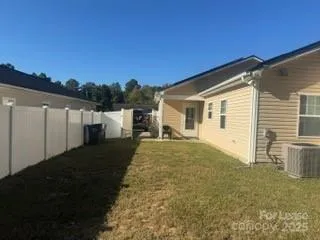 a view of a house with backyard and a garden
