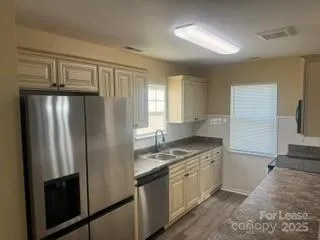a kitchen with stainless steel appliances granite countertop a refrigerator and a stove