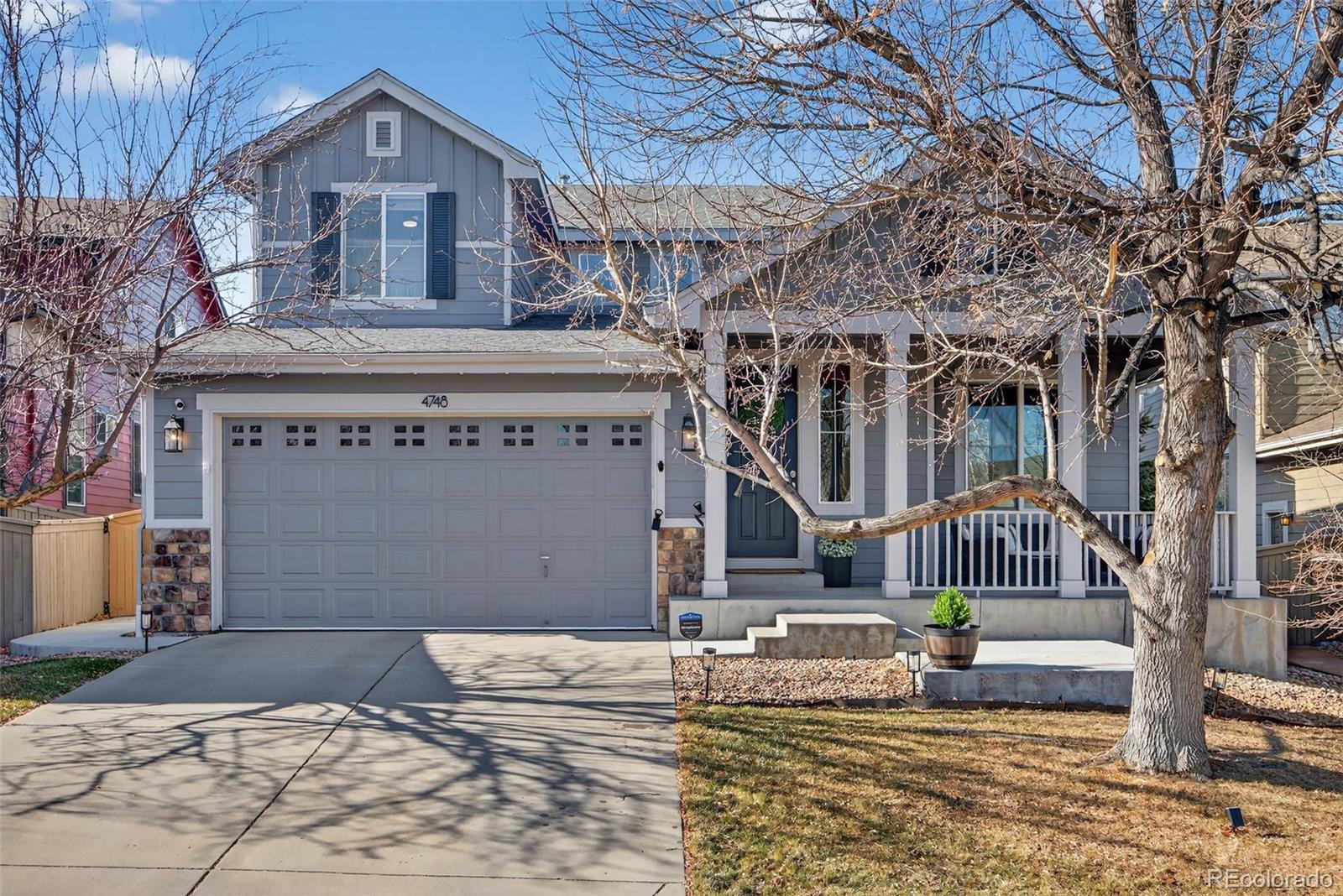 4748 Bluegate Drive Highlands Ranch, CO 80130 - Photo 3 of 49 a front view of a building with a garden