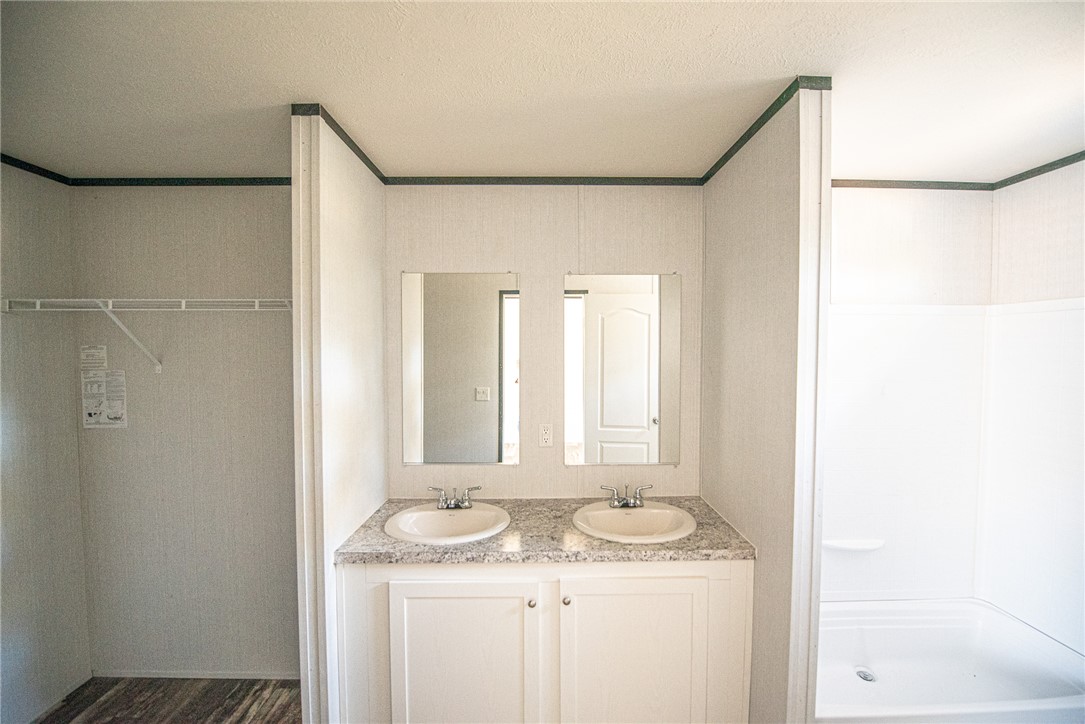 551 Boysenberry Road Somerville, TX 77879 - Photo 12 of 38 a bathroom with a granite countertop sink and a mirror