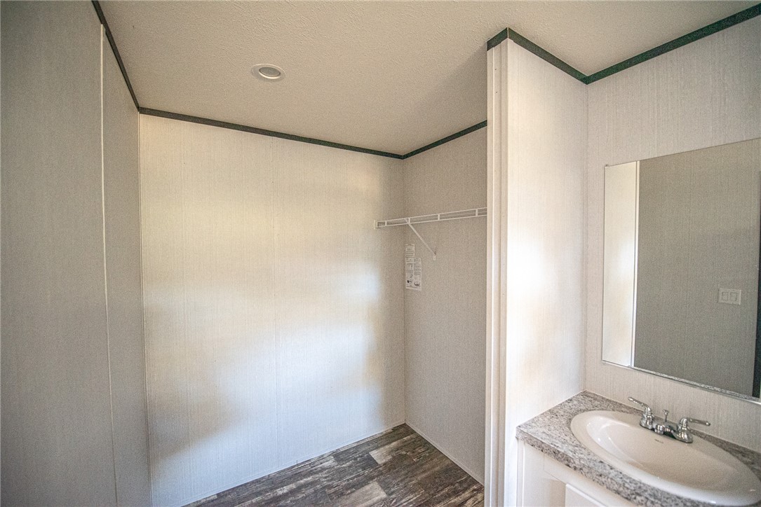551 Boysenberry Road Somerville, TX 77879 - Photo 13 of 38 a bathroom with a granite countertop sink and a mirror