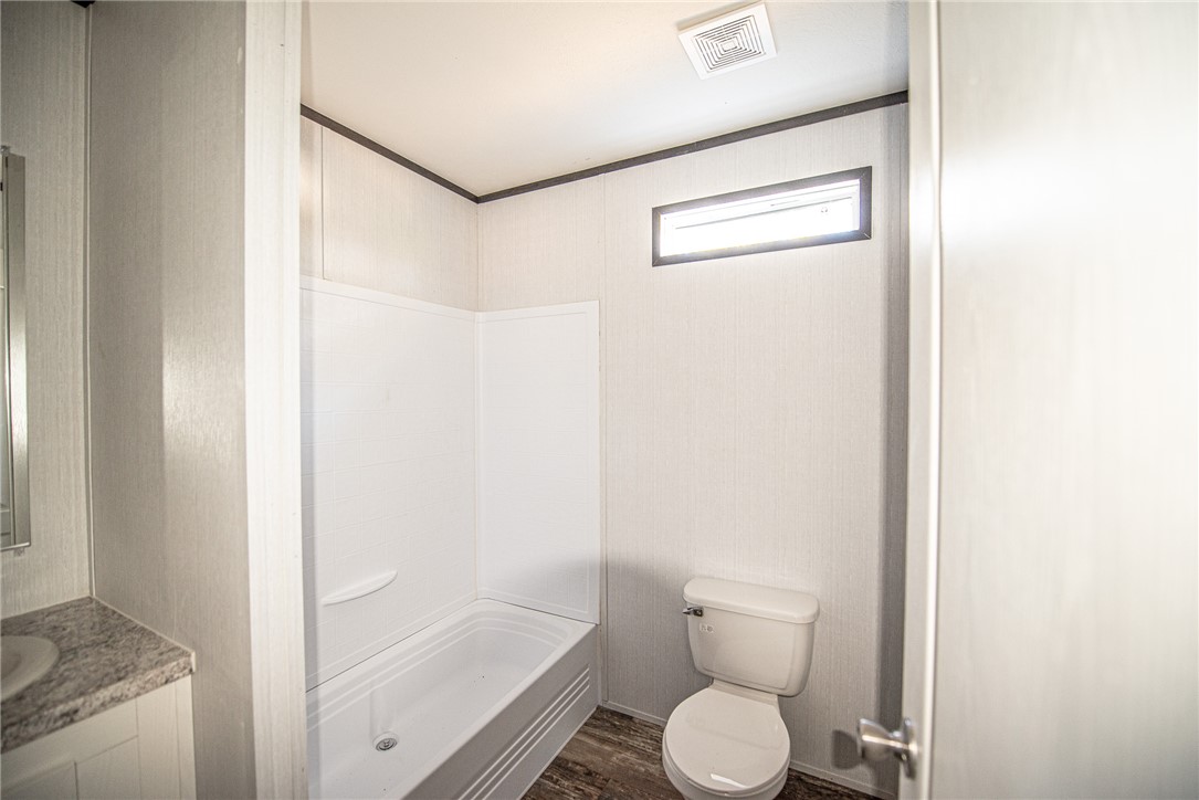 551 Boysenberry Road Somerville, TX 77879 - Photo 15 of 38 a bathroom with a toilet and a shower