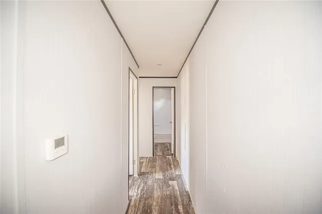 a view of hallway with wooden floor