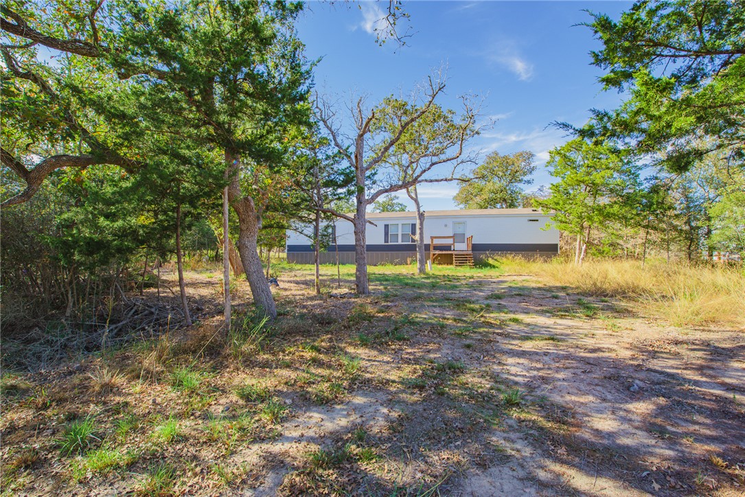 551 Boysenberry Road Somerville, TX 77879 - Photo 2 of 38 a view of a house with a yard