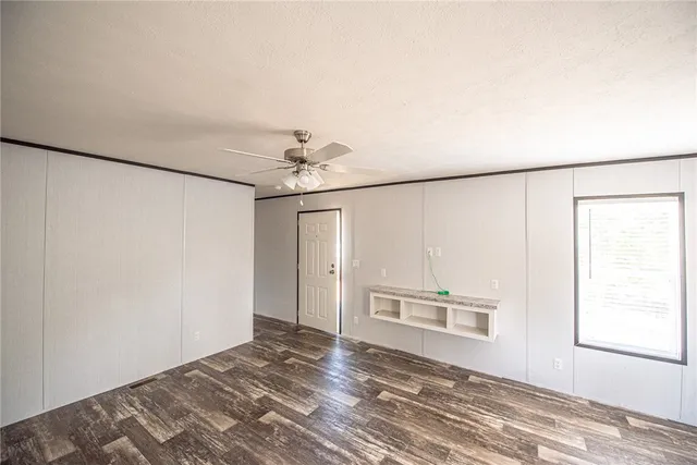a view of a bedroom with a bed and a window