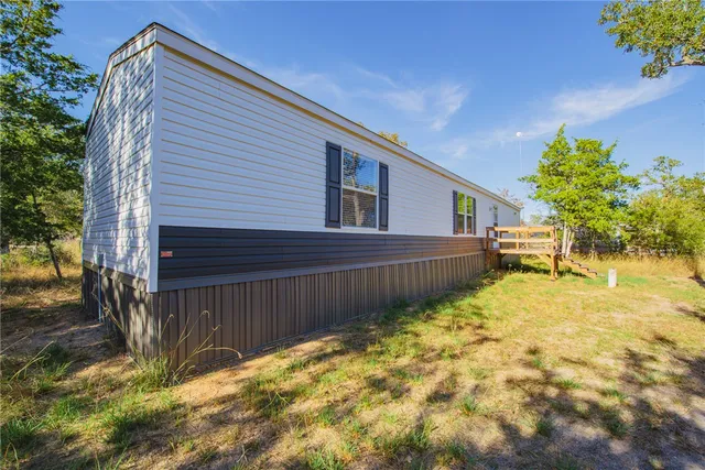 a view of a backyard with wooden fence